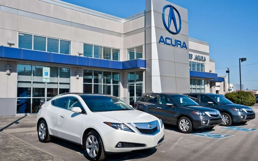 Acura sedans and SUVs parked outside a dealership