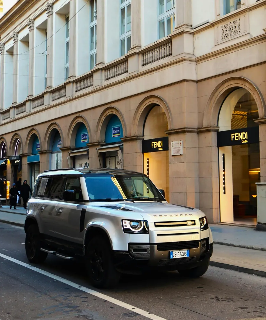 Silver Land Rover Defender parked on a city street